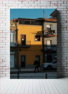 Πίνακας, Man Walking in Front of Colorful Buildings Άνδρας που περπατά μπροστά από πολύχρωμα κτίρια