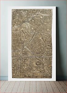 Πίνακας, low relief carving of a Winged Genius, from the Northwest palace of Ashur-Nasir-Pal at Nimrud; a wide band of inscribed writing crosses the slab in the central section